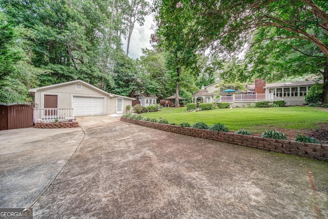 view of yard with a garage, a gazebo, and an outdoor structure