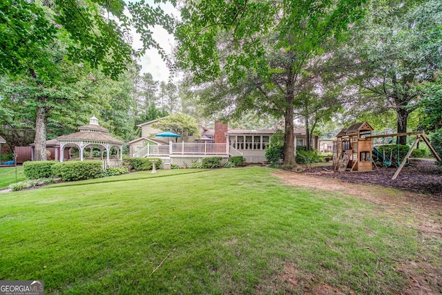 view of yard featuring a gazebo and a playground