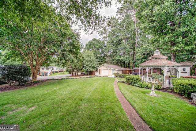 view of yard featuring a garage and a gazebo