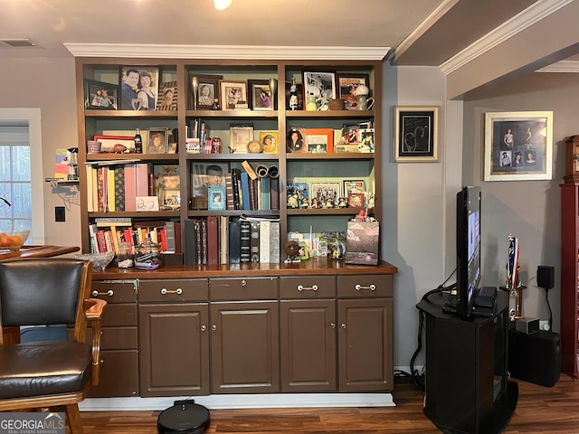 sitting room with ornamental molding and dark hardwood / wood-style flooring