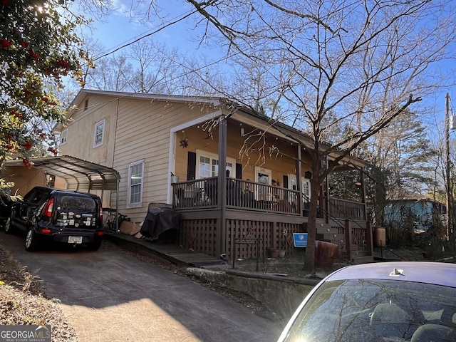 view of front of home with a carport and covered porch