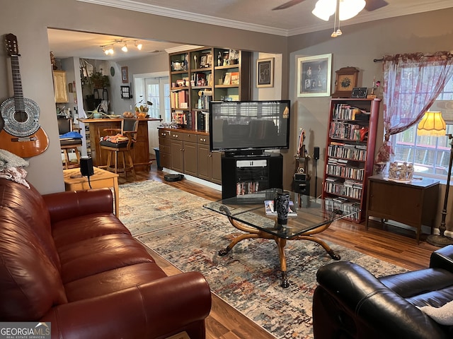 living room with ceiling fan, ornamental molding, and light hardwood / wood-style floors