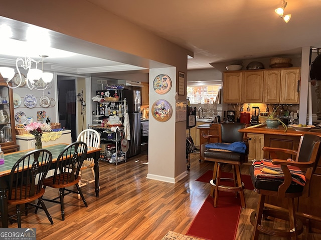 dining space with wood-type flooring and a chandelier