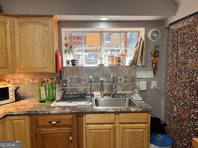 kitchen with tasteful backsplash, sink, and light brown cabinetry