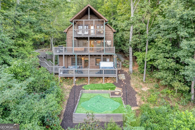 back of house featuring a balcony and a deck