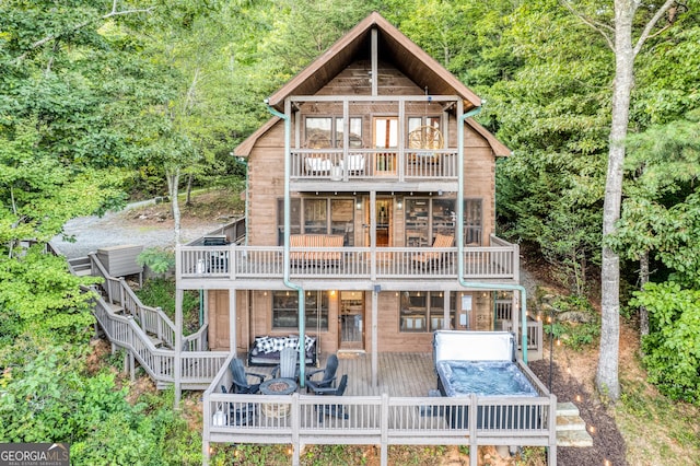 rear view of house with a balcony and a deck