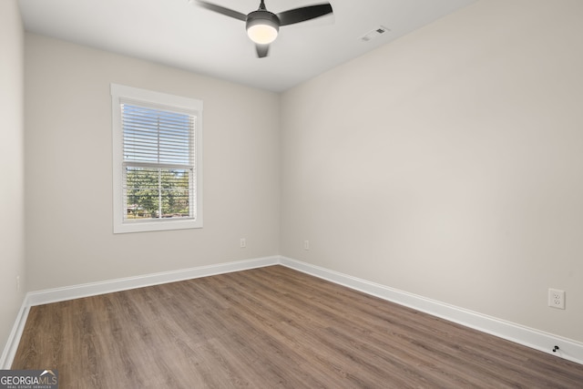 empty room with hardwood / wood-style flooring and ceiling fan