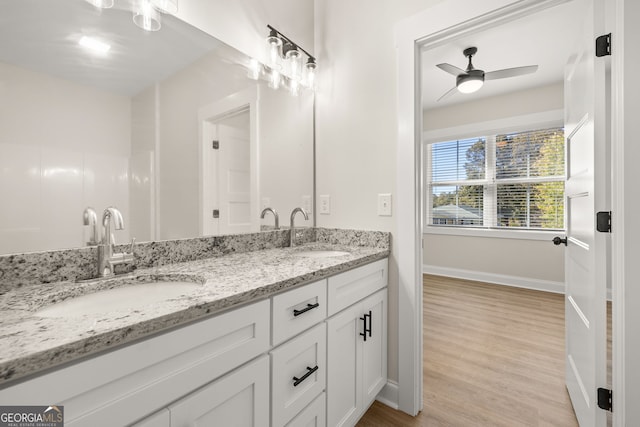 bathroom with vanity, hardwood / wood-style flooring, and ceiling fan