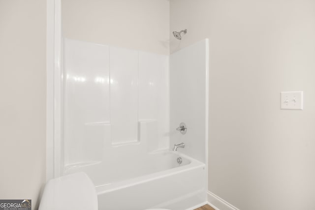 bathroom with toilet and shower / bathing tub combination