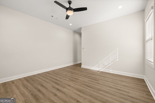 empty room with dark hardwood / wood-style floors and ceiling fan