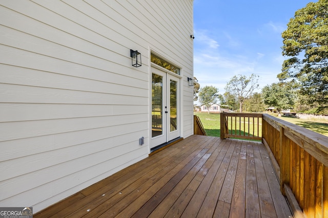 wooden terrace with a lawn