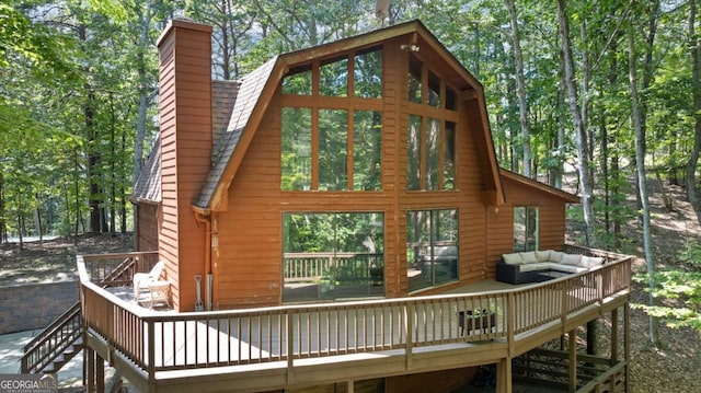 exterior space featuring a wooden deck and an outdoor hangout area