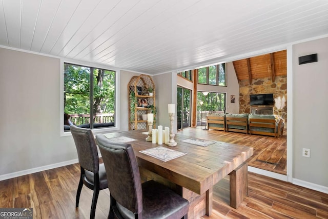 dining room with plenty of natural light, hardwood / wood-style floors, and wooden ceiling