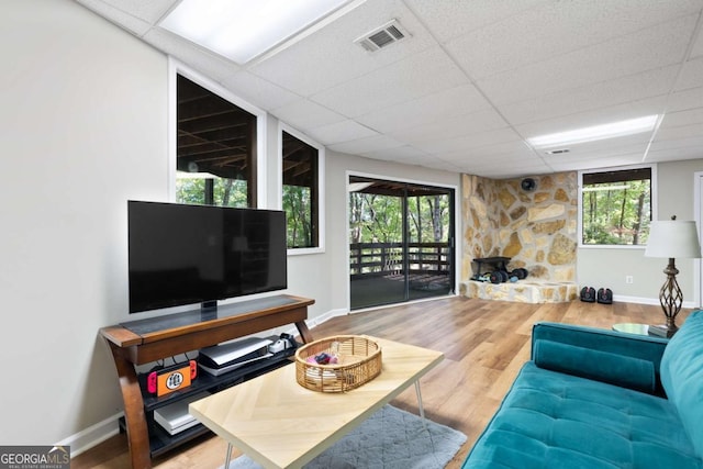 living room featuring a paneled ceiling and wood-type flooring