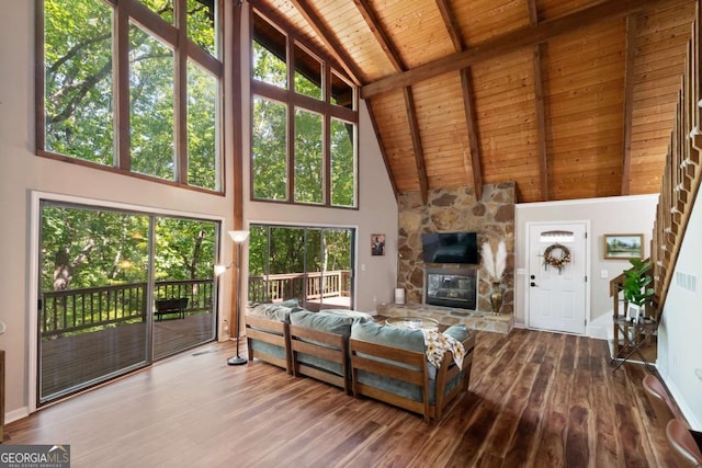 unfurnished living room with wood-type flooring, wooden ceiling, beam ceiling, and a fireplace