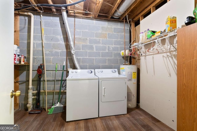 laundry room featuring water heater, washer and dryer, and hardwood / wood-style floors