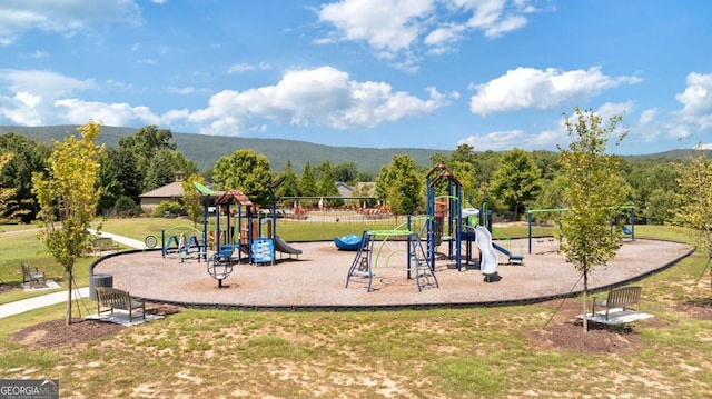 view of play area featuring a yard and a mountain view