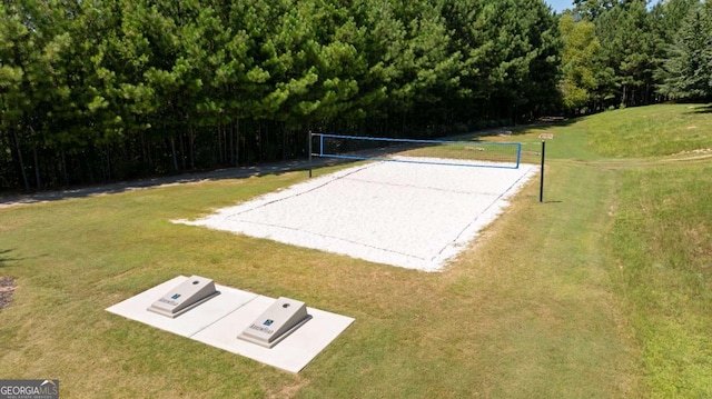 view of home's community with a lawn and volleyball court