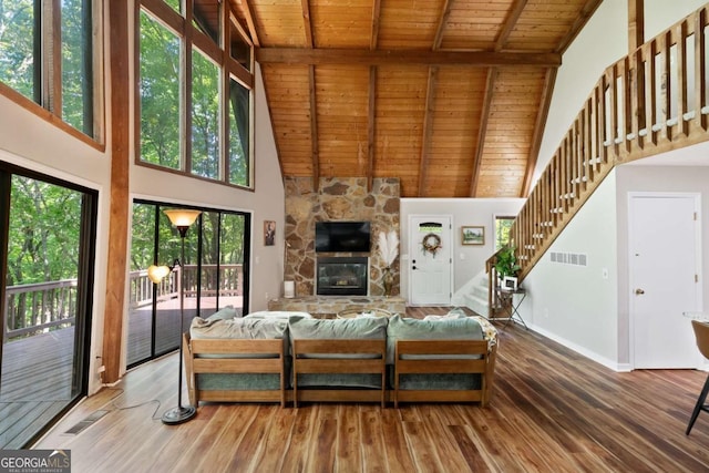 living room featuring high vaulted ceiling, hardwood / wood-style flooring, a fireplace, and wooden ceiling