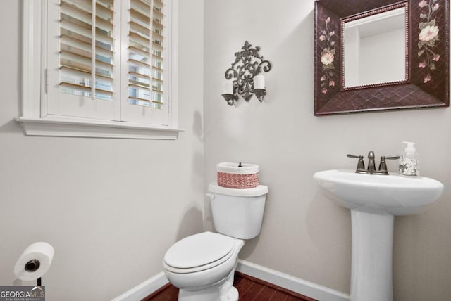 bathroom featuring hardwood / wood-style flooring and toilet