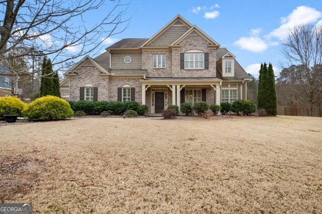 view of front of property with cooling unit and a front lawn