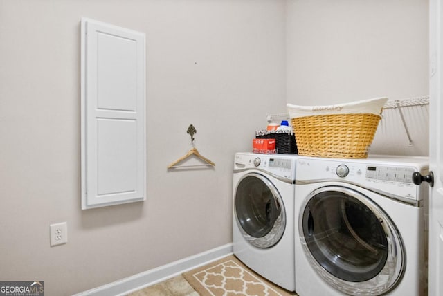 washroom featuring washer and clothes dryer and light tile patterned flooring