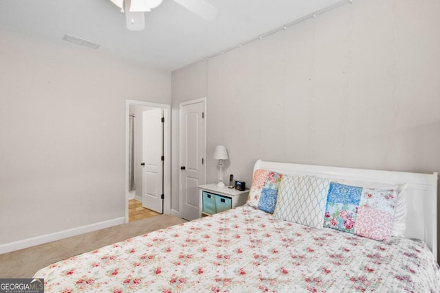 bedroom featuring ceiling fan and light carpet