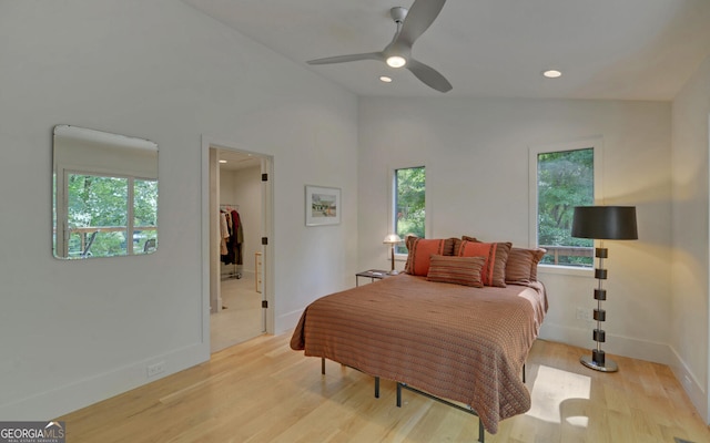 bedroom featuring vaulted ceiling, ceiling fan, and light wood-type flooring