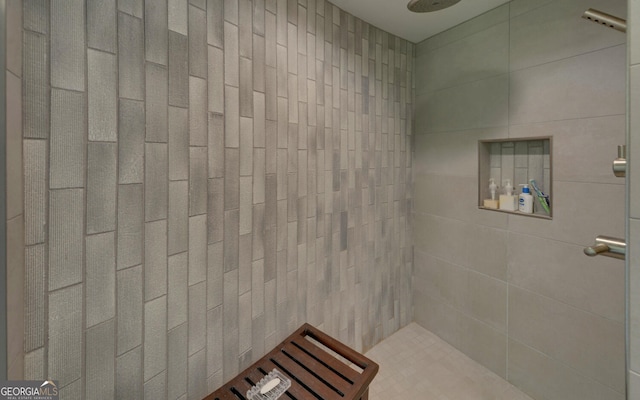 bathroom with a tile shower