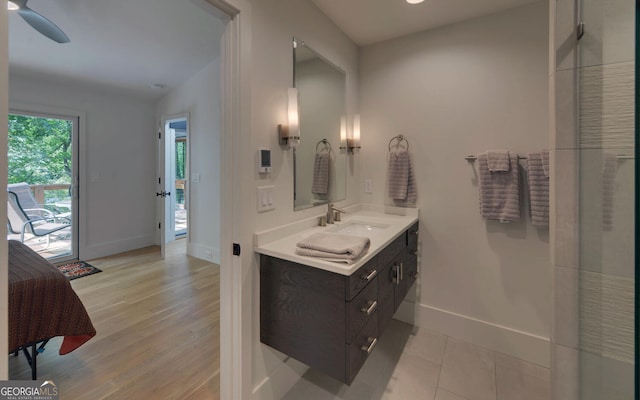 bathroom with vanity, lofted ceiling, hardwood / wood-style floors, and ceiling fan