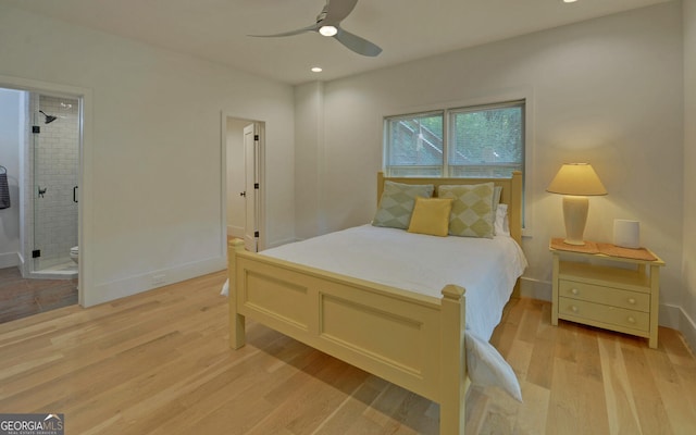 bedroom with ensuite bathroom, light wood-type flooring, and ceiling fan