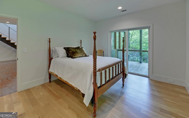 bedroom with light hardwood / wood-style floors and access to outside