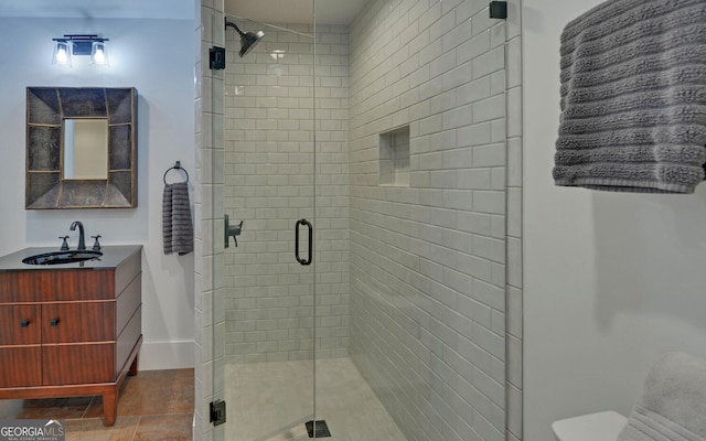 bathroom with vanity, an enclosed shower, and tile patterned floors