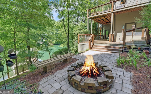 view of patio / terrace with a deck and a fire pit