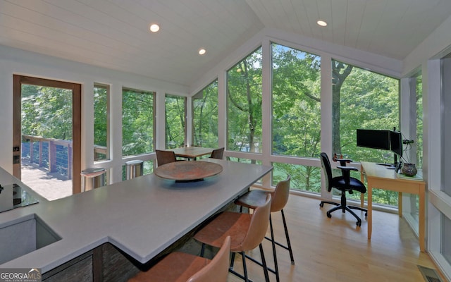 sunroom featuring lofted ceiling