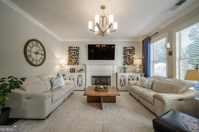 living room with crown molding, an inviting chandelier, and a fireplace