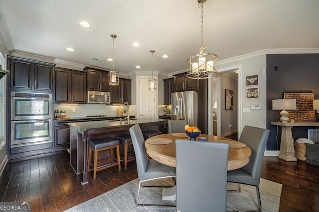 dining area featuring ornamental molding, dark hardwood / wood-style flooring, and sink