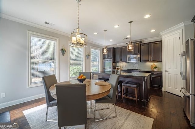 dining area featuring crown molding and dark wood-type flooring