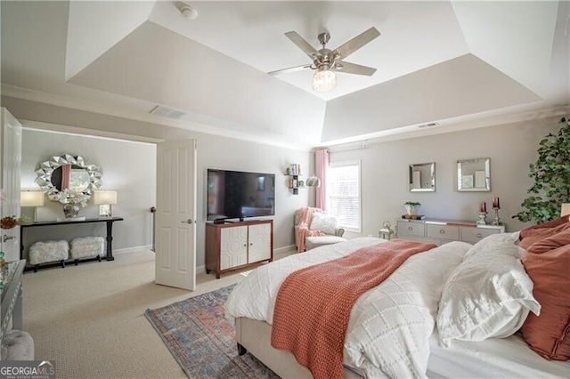 bedroom with ceiling fan, a raised ceiling, and light colored carpet