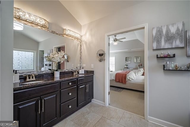 bathroom featuring vanity, plenty of natural light, ceiling fan, and vaulted ceiling