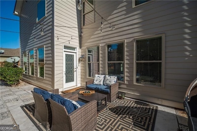 view of patio with an outdoor living space with a fire pit