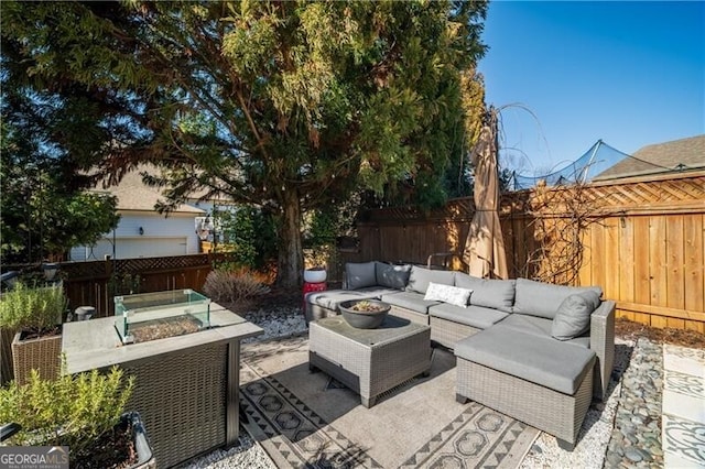 view of patio featuring an outdoor living space with a fire pit