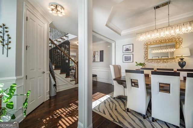 dining area with ornamental molding and dark wood-type flooring