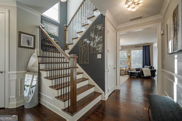 staircase with crown molding and wood-type flooring