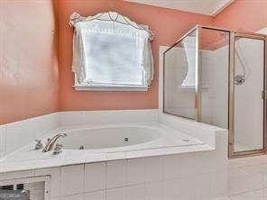 bathroom with tile patterned floors and plus walk in shower