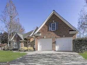 view of front of property with a garage and central AC unit