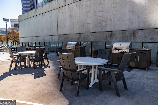 view of patio featuring area for grilling and sink