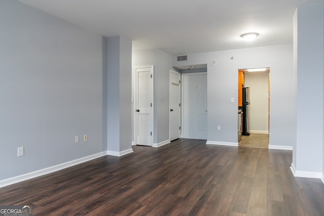 empty room with dark hardwood / wood-style floors