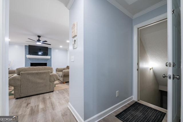 hall featuring crown molding and light wood-type flooring