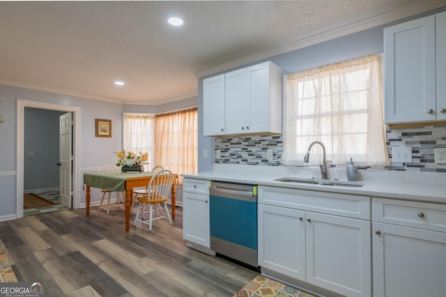 kitchen with sink, ornamental molding, dark hardwood / wood-style floors, dishwasher, and white cabinets